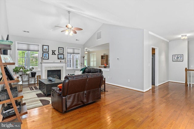 living area with a healthy amount of sunlight, ceiling fan, and visible vents
