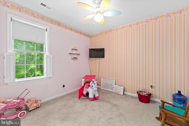 rec room with visible vents, carpet floors, baseboards, wallpapered walls, and a ceiling fan