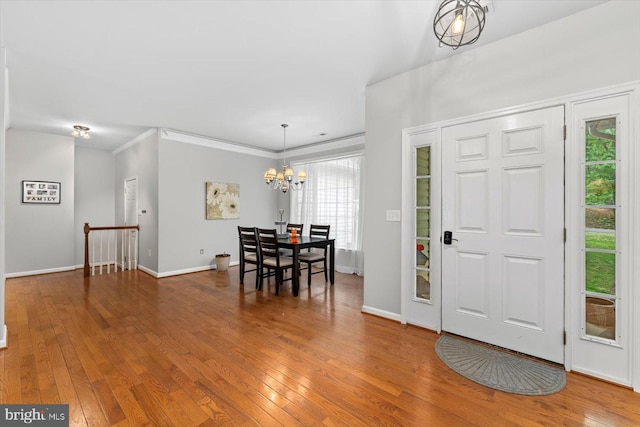 entryway featuring a notable chandelier, a wealth of natural light, and hardwood / wood-style floors