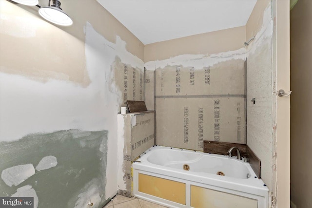 full bath with a whirlpool tub and tile patterned floors