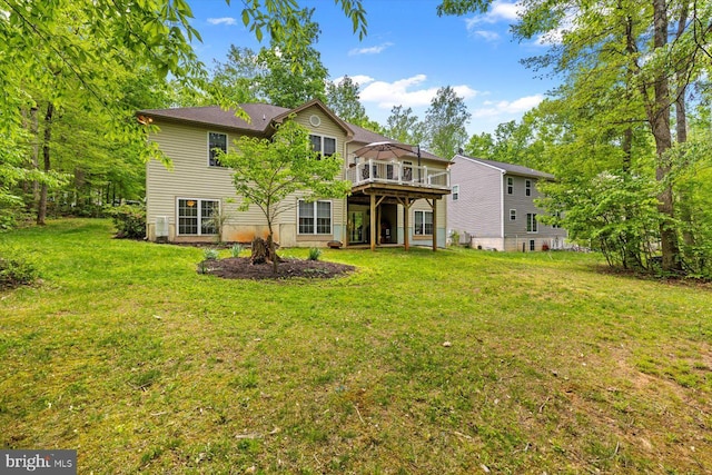 back of house with a lawn and a deck