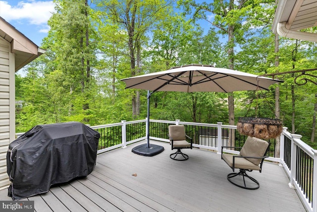 wooden terrace featuring a grill