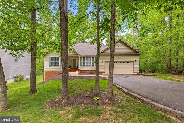 single story home with a shingled roof, an attached garage, a front lawn, and aphalt driveway