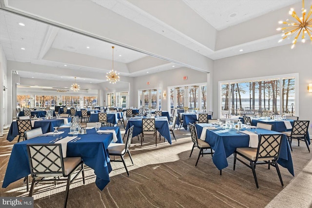 dining space featuring recessed lighting, carpet flooring, a towering ceiling, and a chandelier