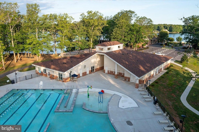 community pool featuring a patio and fence