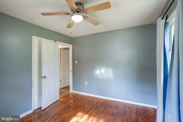 unfurnished bedroom with baseboards, a ceiling fan, and wood finished floors