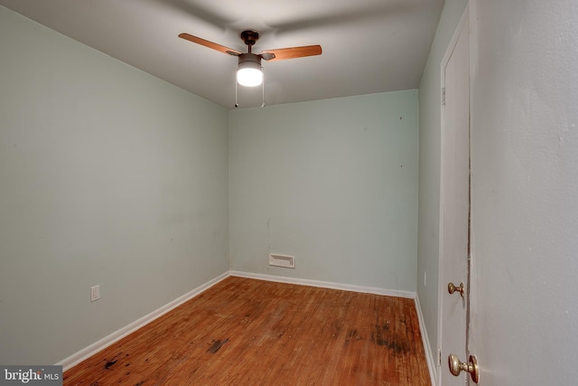 empty room featuring baseboards, a ceiling fan, and wood finished floors