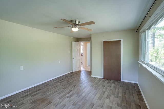 unfurnished bedroom with baseboards, ceiling fan, and wood finished floors