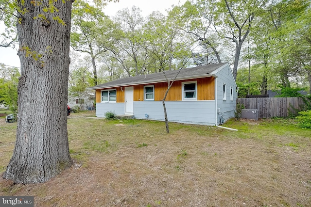 view of side of home featuring fence