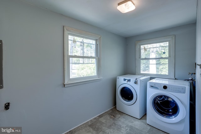 laundry room with separate washer and dryer, laundry area, and baseboards