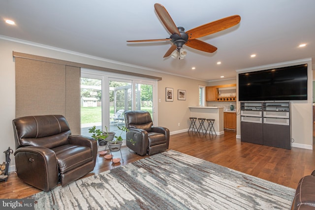 living room with crown molding, baseboards, ceiling fan, and dark wood-style flooring