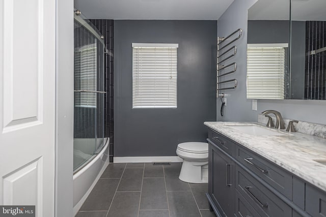 bathroom with vanity, visible vents, toilet, baseboards, and tile patterned floors