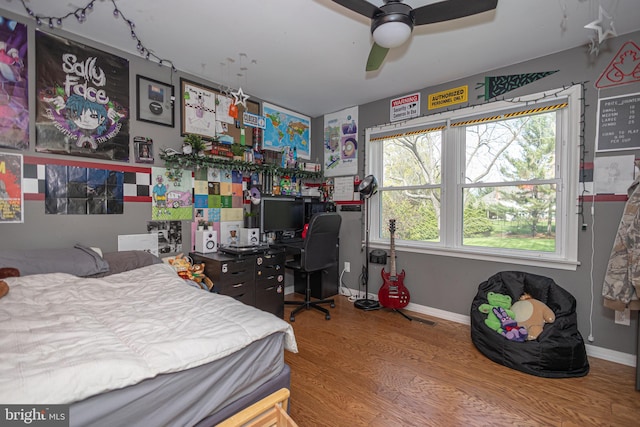 bedroom featuring baseboards, ceiling fan, and wood finished floors