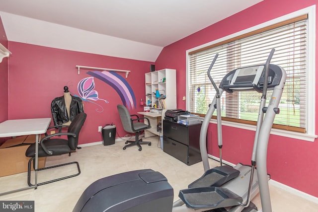 exercise room featuring carpet floors, baseboards, and vaulted ceiling