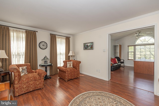 sitting room featuring a ceiling fan, wood finished floors, a wealth of natural light, and ornamental molding