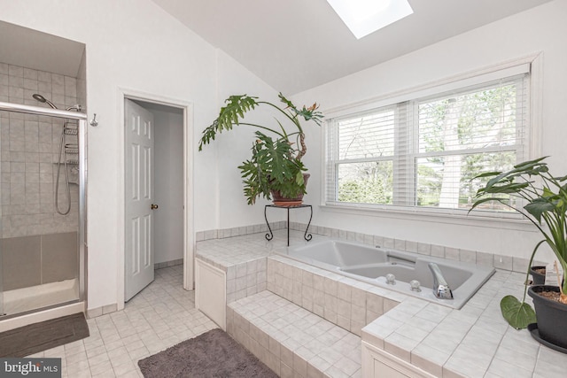 full bathroom with tile patterned flooring, a shower stall, lofted ceiling with skylight, and a garden tub
