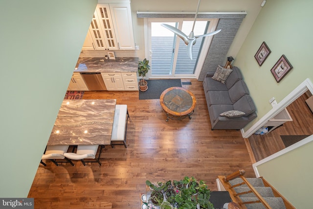 living area featuring light wood-style flooring and stairway