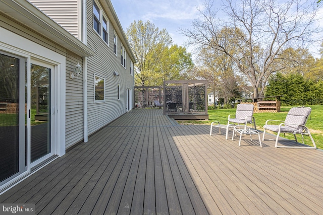 wooden deck featuring a lawn