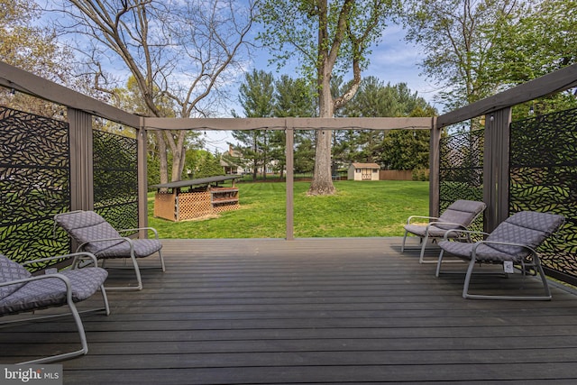 deck featuring an outbuilding and a yard