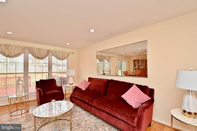living room with recessed lighting, baseboards, and wood finished floors