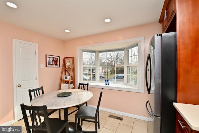 dining room featuring light tile patterned floors, baseboards, recessed lighting, and visible vents