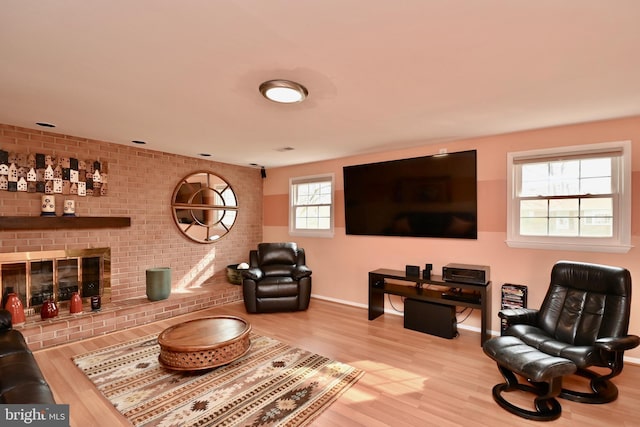 living room with baseboards, a fireplace, and wood finished floors