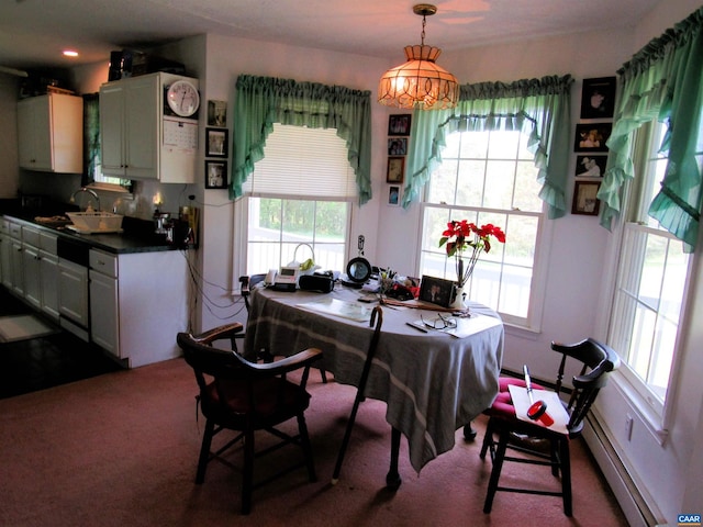 carpeted dining room featuring a sink and a baseboard radiator