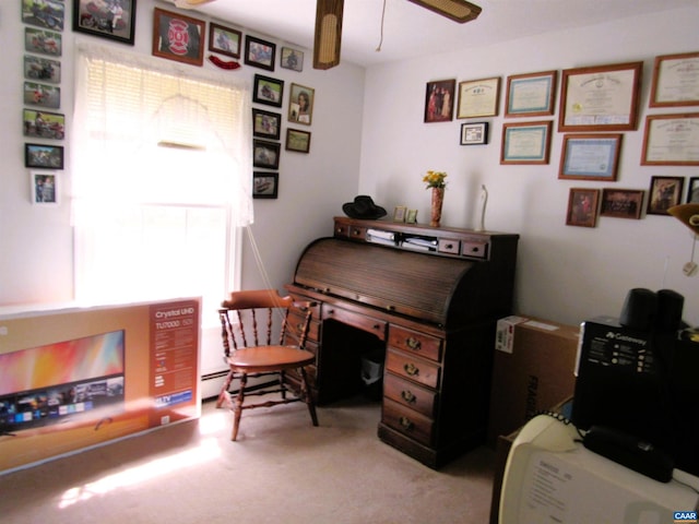 carpeted office space with a ceiling fan