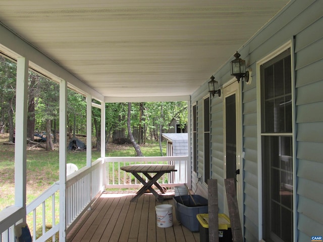wooden terrace featuring covered porch