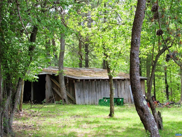 view of pole building with a wooded view