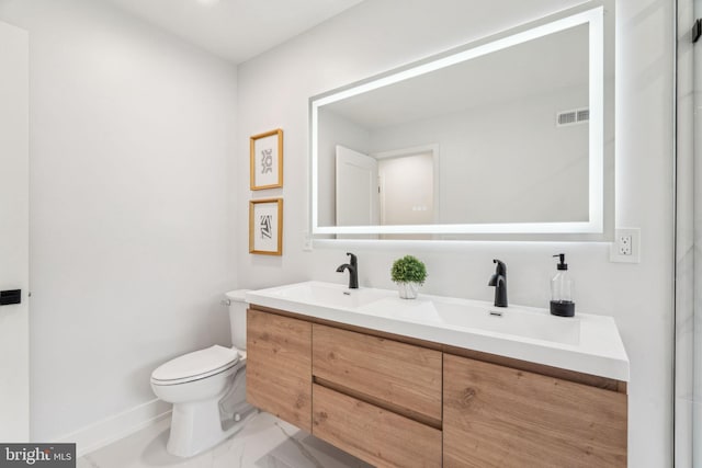 1104 N Bodine St, Philadelphia, PA 19123 - bathroom featuring double vanity, visible vents, a sink, toilet, and marble finish floor