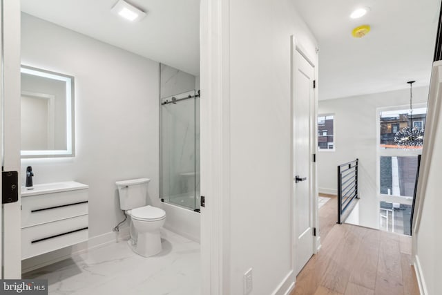 1104 N Bodine St, Philadelphia, PA 19123 - bathroom featuring shower / bath combination with glass door, vanity, toilet, a chandelier, and baseboards
