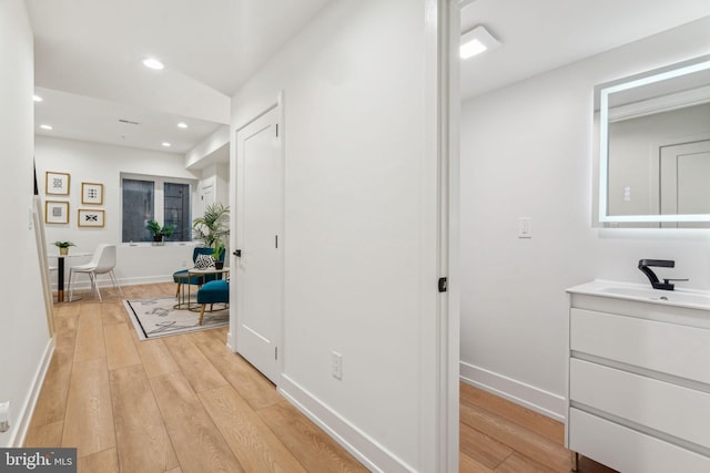 1104 N Bodine St, Philadelphia, PA 19123 - corridor with a sink, recessed lighting, baseboards, and light wood finished floors
