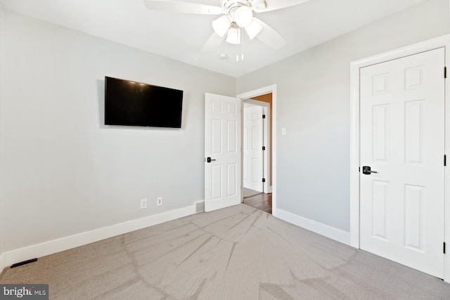 unfurnished bedroom with carpet floors, a ceiling fan, baseboards, and visible vents