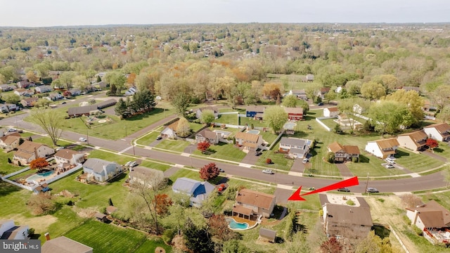 bird's eye view with a wooded view and a residential view