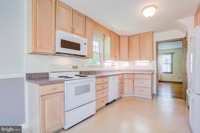 kitchen with white appliances and light brown cabinets