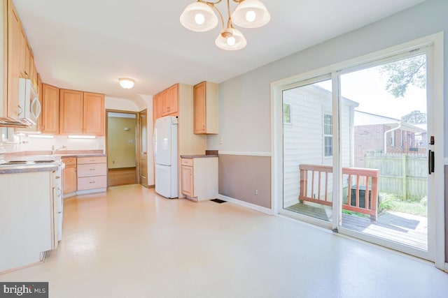 kitchen featuring finished concrete flooring, baseboards, an inviting chandelier, light brown cabinets, and white appliances