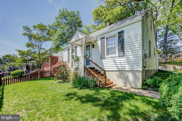 view of front of property featuring fence, a chimney, and a front yard