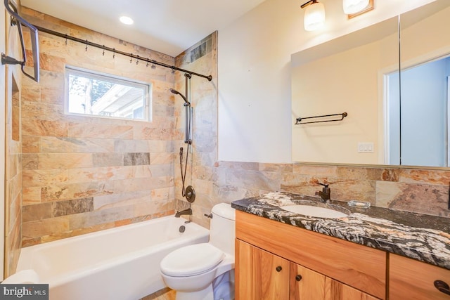 full bath with vanity, shower / washtub combination, toilet, and tile walls