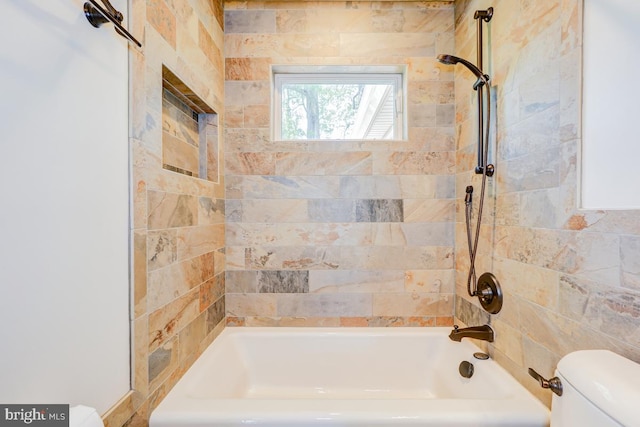 bathroom featuring shower / bathtub combination and toilet