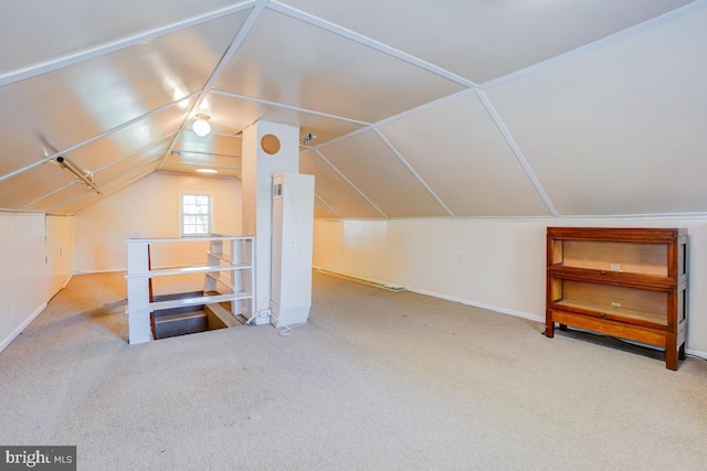 additional living space featuring vaulted ceiling, baseboards, and carpet flooring