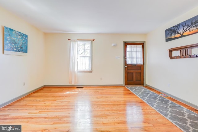entryway with baseboards, wood finished floors, and a healthy amount of sunlight