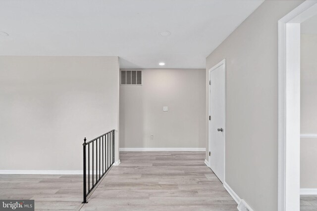 hallway featuring baseboards, recessed lighting, light wood-style flooring, and visible vents