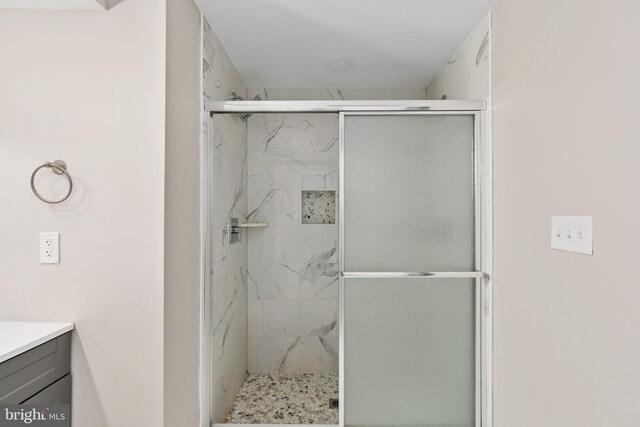 full bathroom featuring vanity and a shower stall