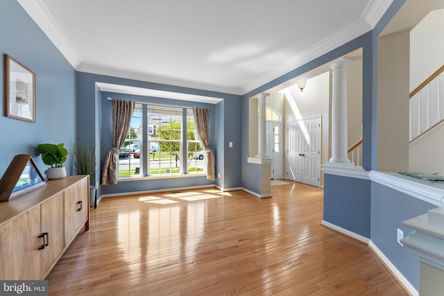 foyer featuring stairway, baseboards, decorative columns, and light wood-type flooring