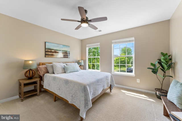 bedroom featuring light colored carpet, baseboards, and visible vents