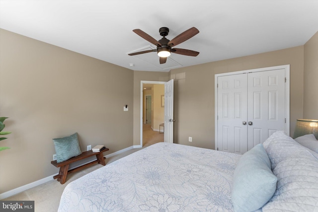 bedroom with light colored carpet, a ceiling fan, baseboards, and a closet