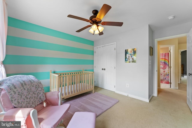 carpeted bedroom with baseboards, a ceiling fan, and a closet