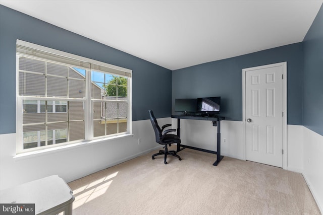 carpeted office space featuring baseboards