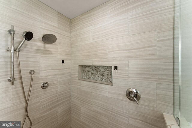full bathroom with a tile shower